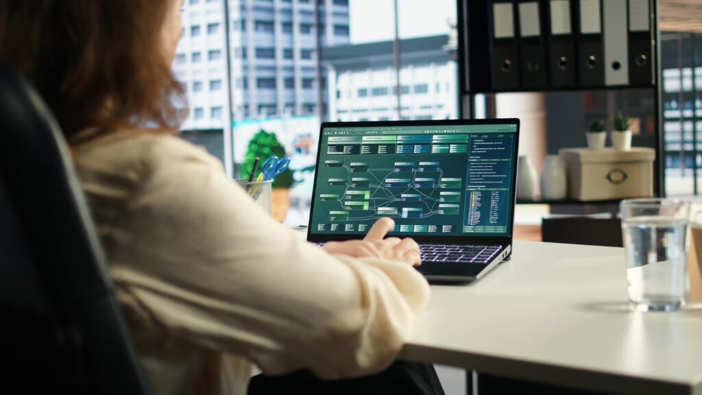 woman typing on the keyboard and analyzing data
